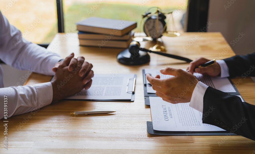 The business lawyer working about legal legislation in courtroom to help their customer, the Lawyer working with a client discussing contract paper The business lawyer working about legal legislation in courtroom to help their customer, the Lawyer working with a client discussing contract paper