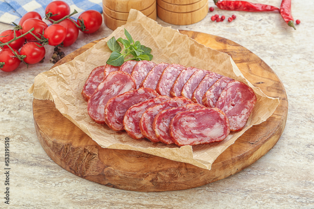 Sliced salami sausages over board Sliced salami sausages over board