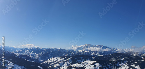 Panorama of the snow capped Alps and the view from the Griessenkareck summit near Flachau in Austria  on a sunny winter day.