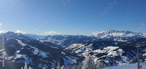 Panorama of the snow capped Alps and the view from the Griessenkareck summit near Flachau in Austria, on a sunny winter day.