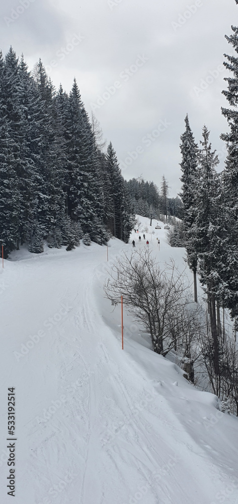 View from the chairlift to the ski runs on a cloudy winter day in Flachau, Austria.