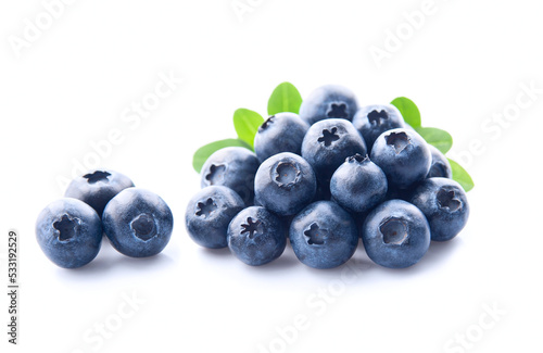 Sweet blueberries with leaves closeup on white backgrounds.