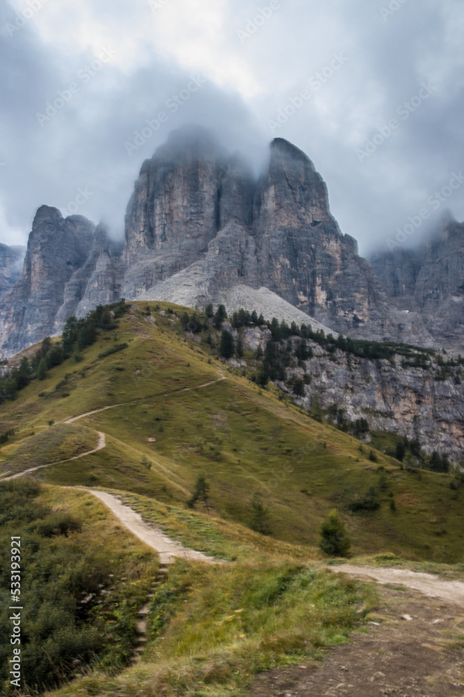Clouds over mountain trail Gardena Pass in Dolomites