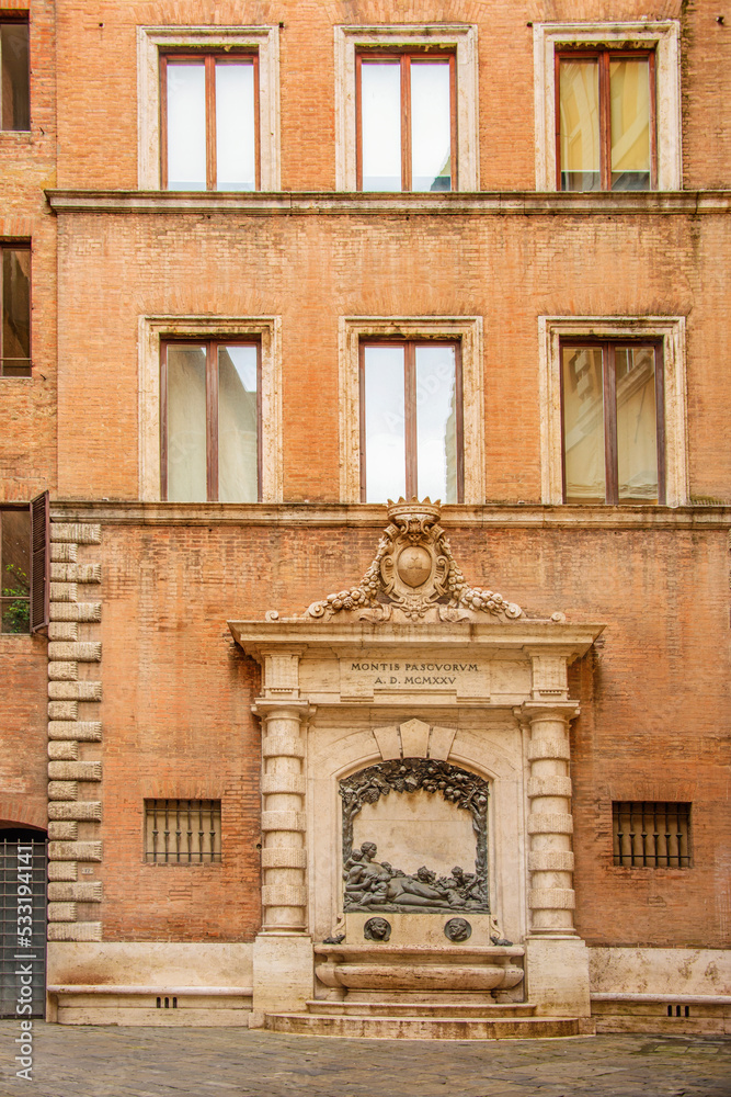 Facade of old buildings in the historical center of Siena, the UNESCO World Heritage Centre, unchanged for 13-14 centuries, with its medieval streets looked like in the early Middle Ages. Italy, 2019