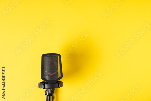 Microphone on a yellow background with a space for text.