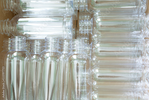 beverage bottle industry The empty PET bottles on the conveyor belt for filling process in the drinking water factory. The hi-technology of plastic bottle manufacturing process.