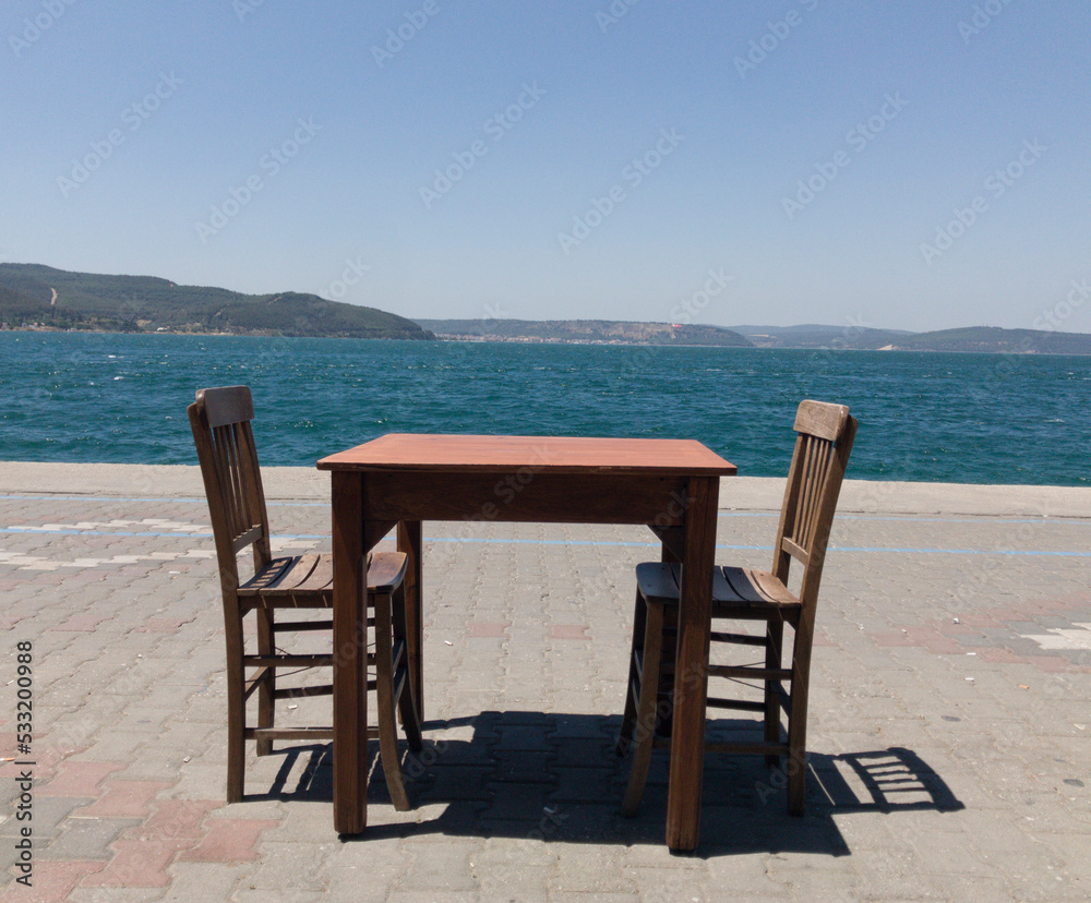 a table and two chairs waiting for a couple to sit.