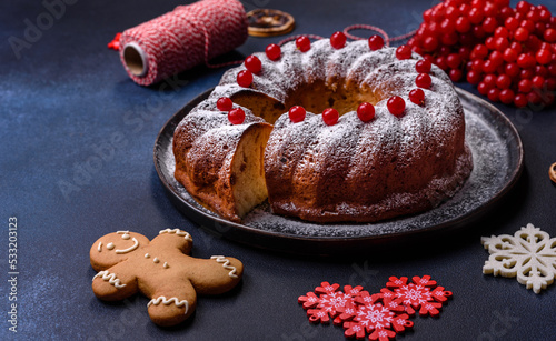Homemade delicious round Christmas pie with red berries on a ceramic plate