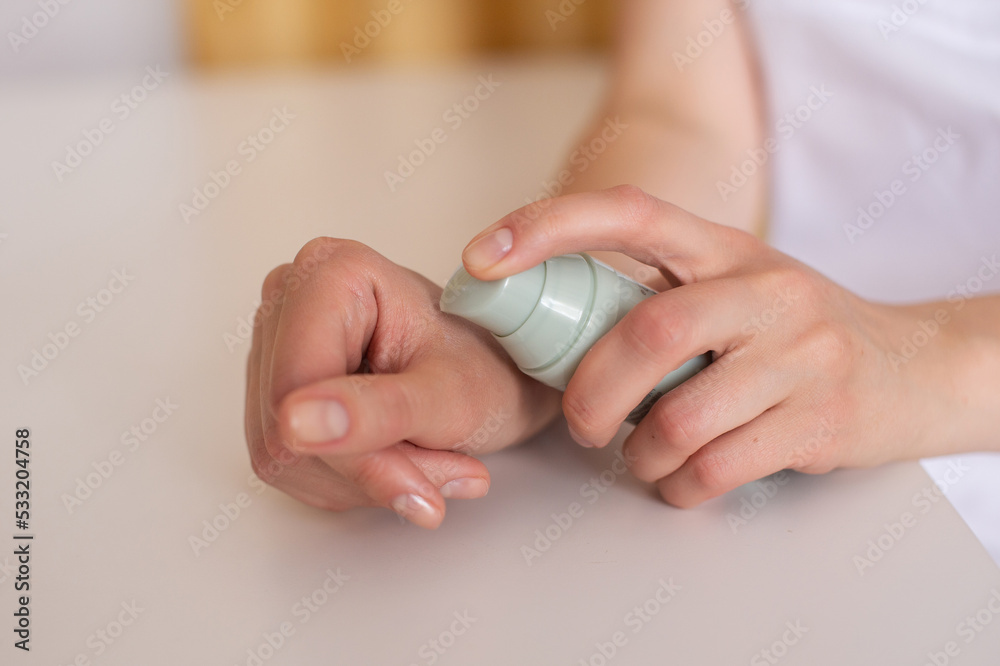 Squeeze the cosmetic product from the bottle onto your hand Squeeze the cosmetic product from the bottle onto your hand