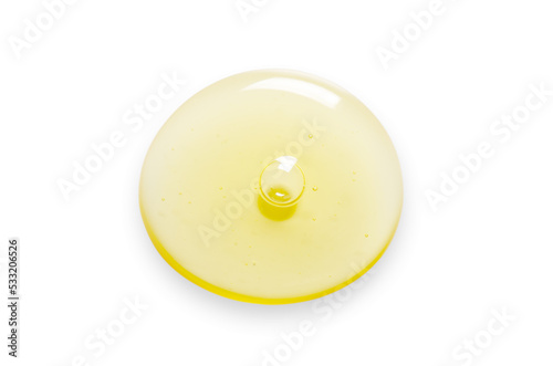Yellow drops of gel close up. Cosmetic product for moisturizing the skin of the face or body. Isolated on a white background. photo