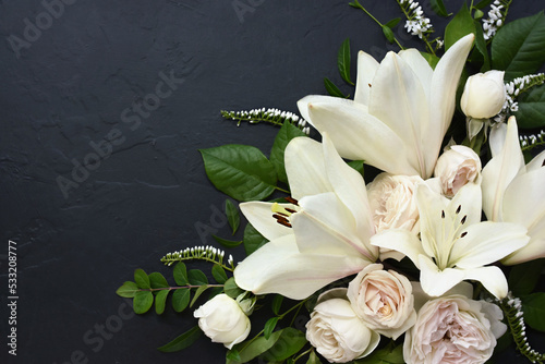 White delicate lily flowers composition, condolence flower background card, funeral concept image, selective focus, shallow DOF