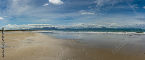 panorama view of the endless golden sand beach in Ballyheigue on the west coast of Ireland