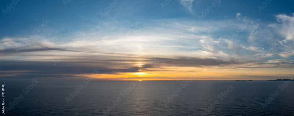 panorama seascape of a calm Atlantic Ocean at sunset with an expressive sky