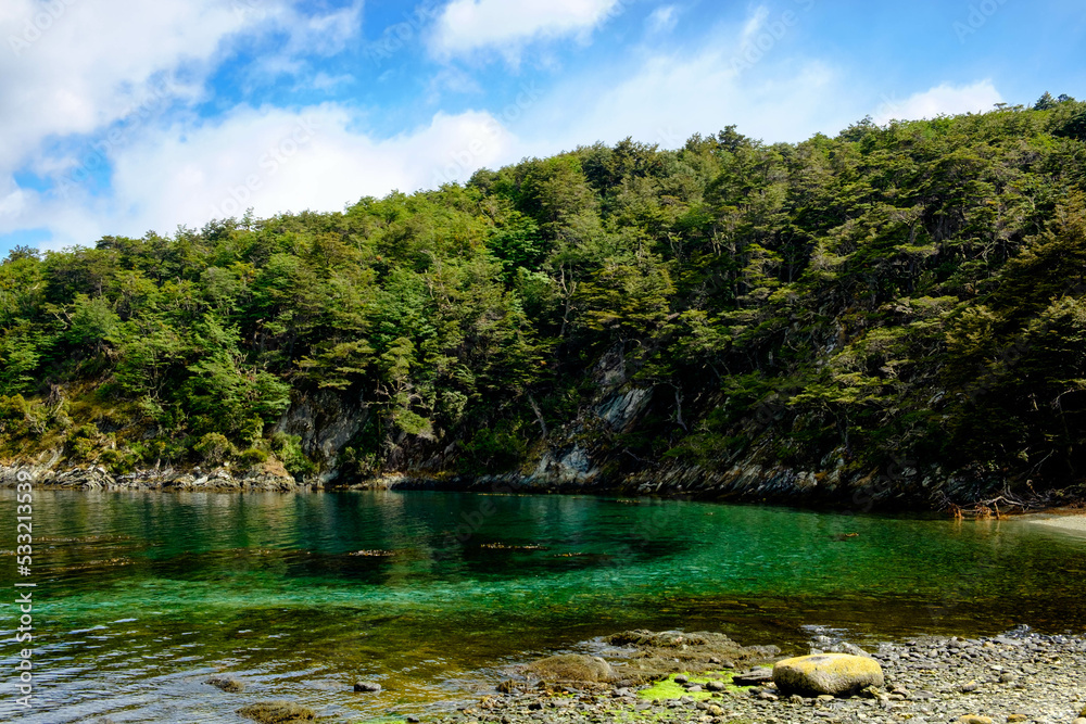 Turquoise coloured water at a beach at the Beagle Channel in Tierra del Fuego National Park in Ushuaia.