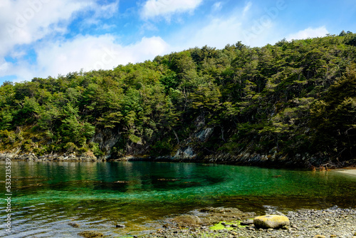 Turquoise coloured water at a beach at the Beagle Channel in Tierra del Fuego National Park in Ushuaia.