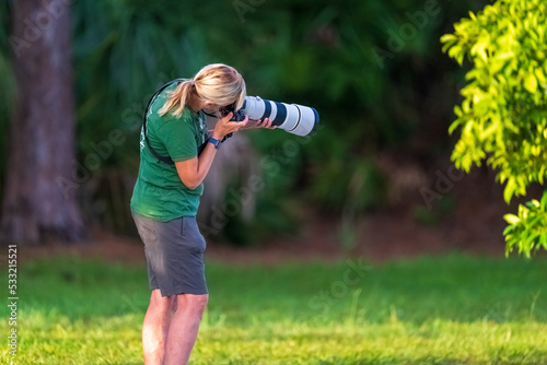 Lady wildlife photograper with Sony a7rlV and Sony 200-600mm GM photo