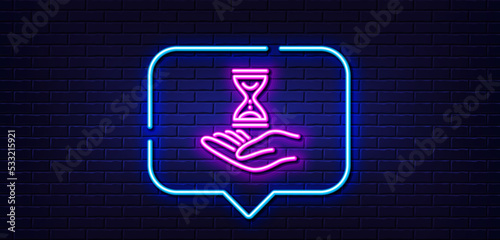 Neon light speech bubble. Time hourglass in hand line icon. Sand watch sign. Neon light background. Time hourglass glow line. Brick wall banner. Vector