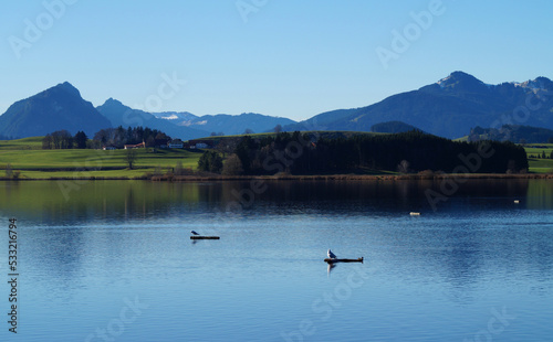 scenic and serene lake Hopfensee in Schwangau with the Bavarian Alps in the background on a sunny November day (Allgaeu, Bavaria, Germany)