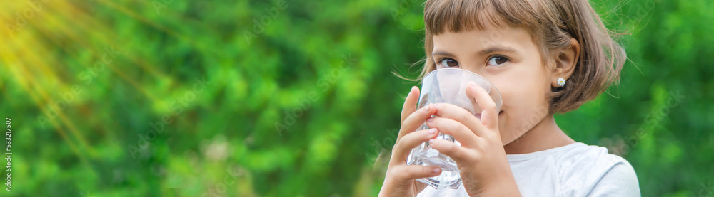 child drinks water from a glass. Selective focus. child drinks water from a glass. Selective focus.