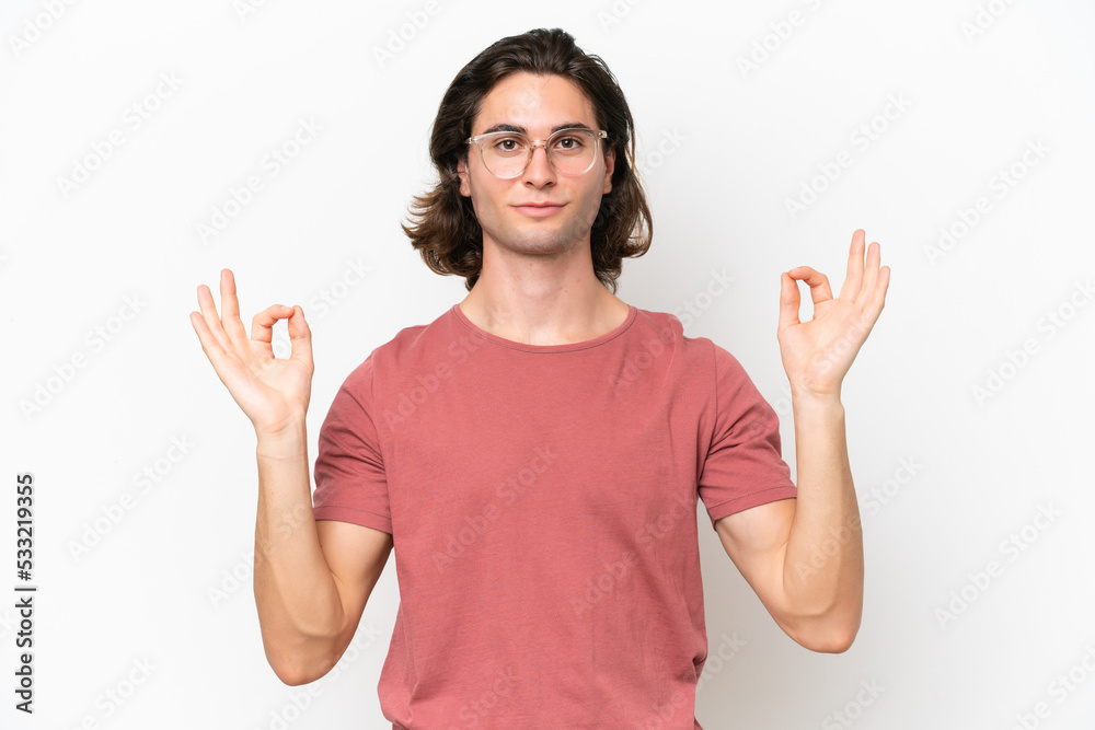 Young handsome man isolated on white background in zen pose Young handsome man isolated on white background in zen pose