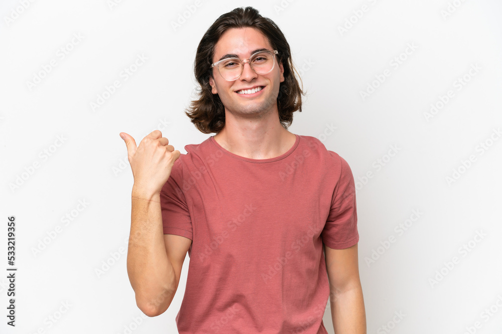 Young handsome man isolated on white background pointing to the side to present a product Young handsome man isolated on white background pointing to the side to present a product