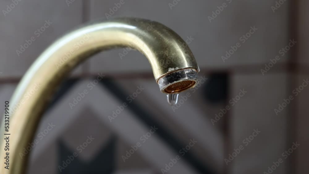 Water Dripping From Faucet. Drop Of Water Drips From The Water Vintage Bronze Tap In A Kitchen. Dolly Slider Shot. 60 FPS, 4k, ProRes Water Dripping From Faucet. Drop Of Water Drips From The Water Vintage Bronze Tap In A Kitchen. Dolly Slider Shot. 60 FPS, 4k, ProRes