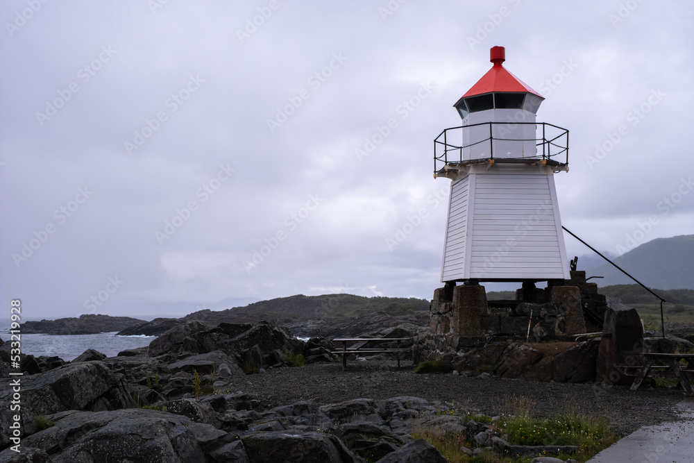 Obraz premium Laukvik, Norway - July 17, 2022: Laukvik Fyr is a coastal lighthouse in the Lofoten Islands in Nordland county. Selective focus.
