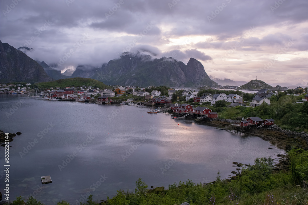 Reine, Sorvagen Norway - July 18, 2022: Beautiful scenery of Reine town and surroundings on the Lofoten Islands. Summer cloudy day. Selective focus.