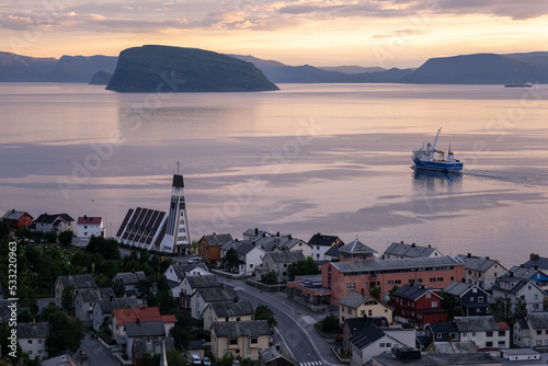 Hammerfest, Norway - July 26, 2022: Beautiful scenery of Hammerfest town and surroundings on the Kvaloya Island during sunset. Summer cloudy day. Selective focus. photo