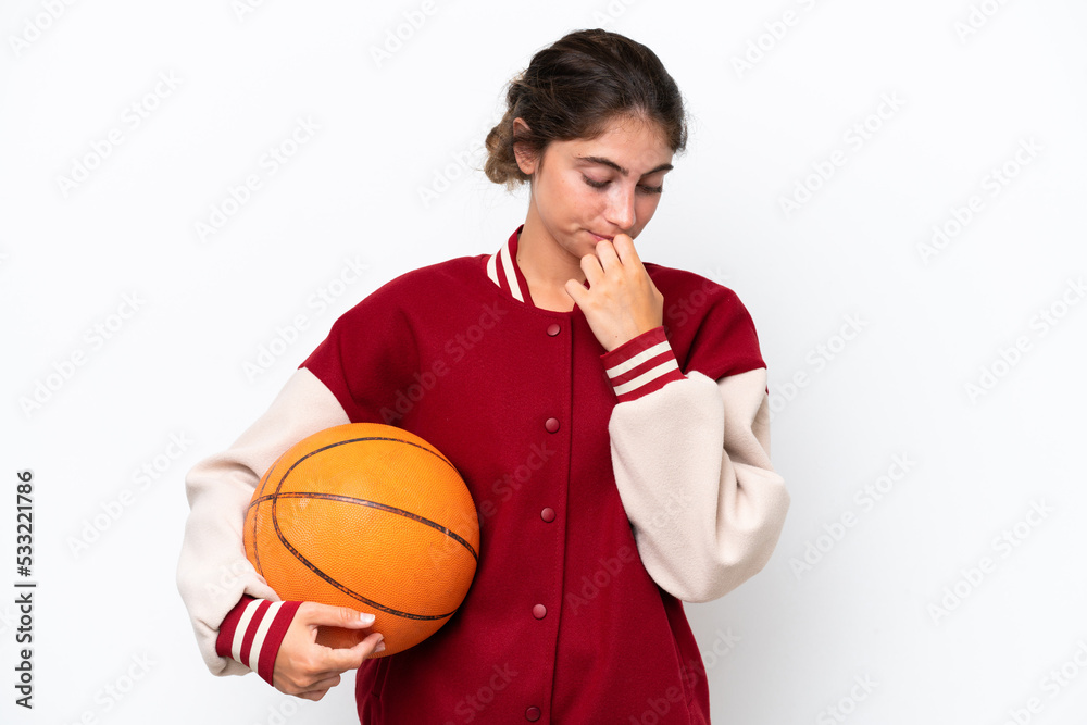 Young basketball player woman isolated on white background having doubts
