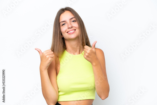 Young caucasian woman isolated on white background with thumbs up gesture and smiling