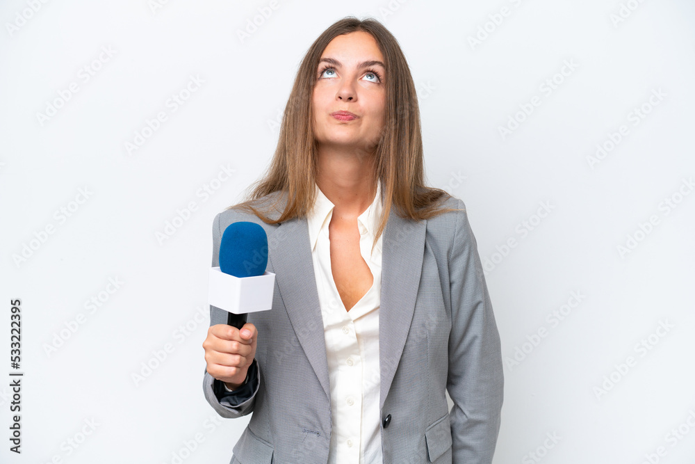 Young TV presenter caucasian woman isolated on white background and looking up Young TV presenter caucasian woman isolated on white background and looking up