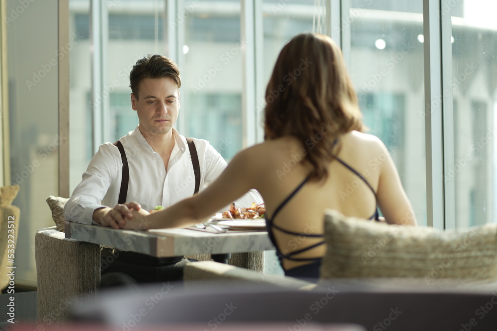Couple dating and flirting in a restaurant. couple dating , propose marriage. Romantic couple on a date sitting in a restaurant. Couple dating and flirting in a restaurant. couple dating , propose marriage. Romantic couple on a date sitting in a restaurant.