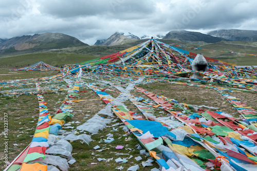 Nyenchen Tonglha pass. Prayer flags next to the base of Mount Nyenchen Tanglha 7111 meters high, Tibet China. One of the holy mountains for Tibetans, Tibet