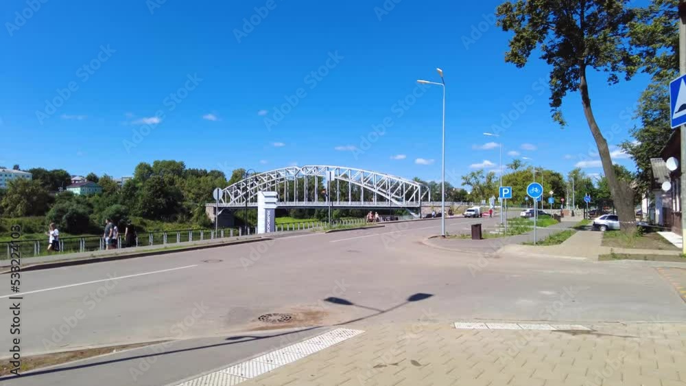 View on the embankment and steel arch bridge on the Msta river View on the embankment and steel arch bridge on the Msta river