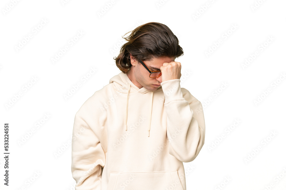 Young caucasian man isolated on green chroma background with headache Young caucasian man isolated on green chroma background with headache