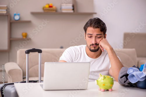 Young man preparing for trip at home