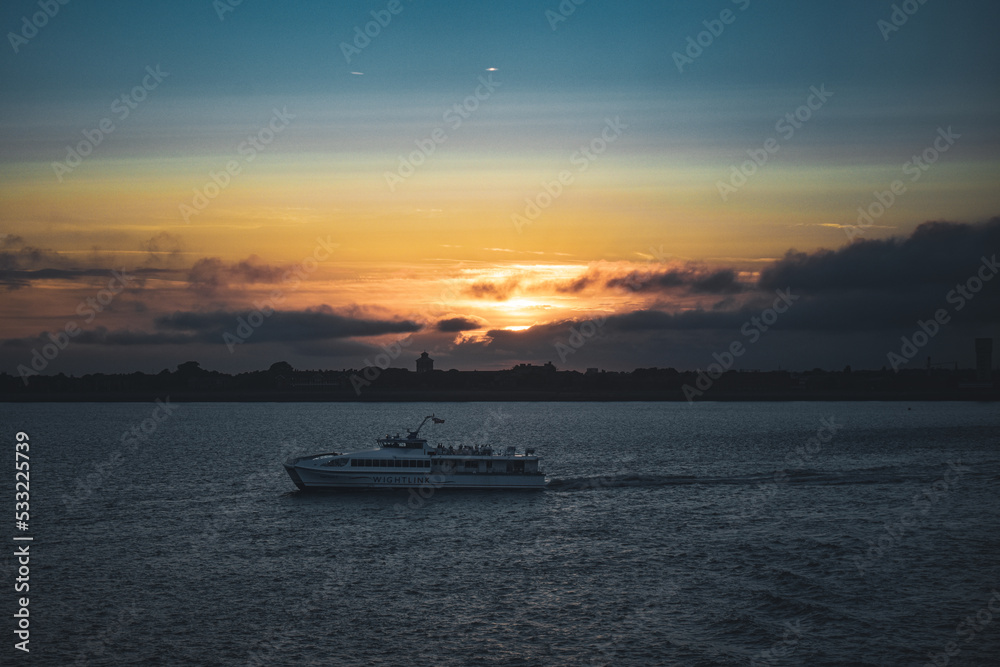 sailboat against Orange red blue sunset sunrise with blue ocean sea land port harbour sailboat against Orange red blue sunset sunrise with blue ocean sea land port harbour