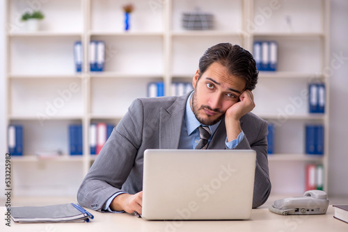 Young male employee working in the office