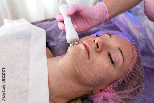 Micro current therapy. Cosmetology beauty skincare procedure by beautician.  © Irina