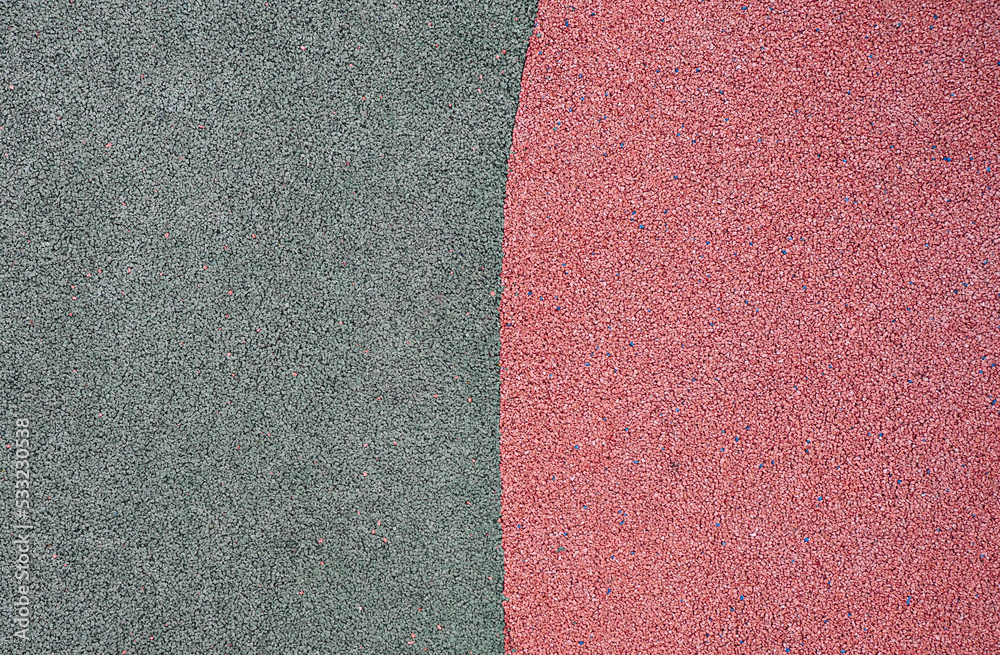 Fototapeta premium green and red pebbles texture background. park or playground flooring material. complementary colors