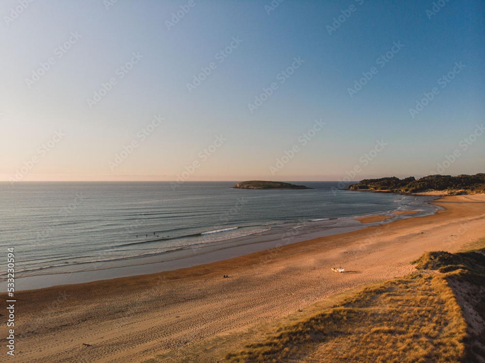 Panoramic view of the coast at sunset during a surf and travel week experience in Somo, Cantabria (Spain)