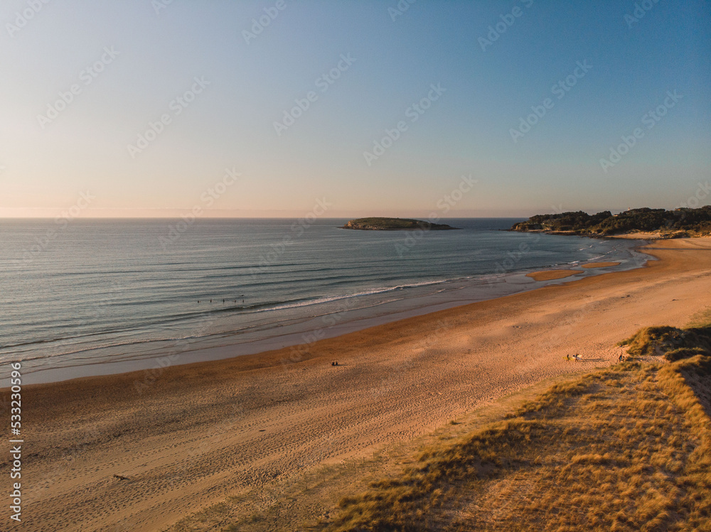 Panoramic view of the coast at sunset during a surf and travel week experience in Somo, Cantabria (Spain)