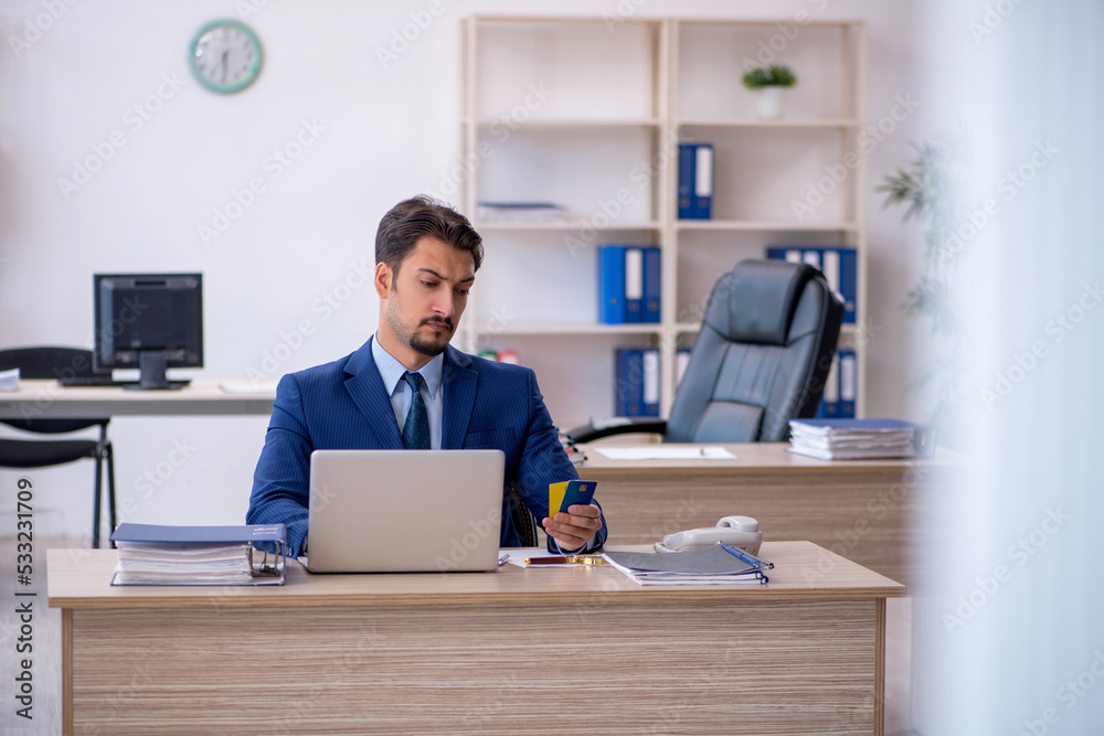 Young male employee working in the office Young male employee working in the office