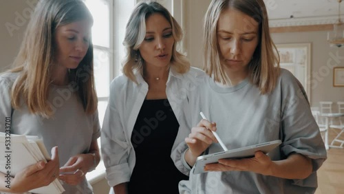 Woman interior decorator planning wedding preparation use tablet consulting female customer
