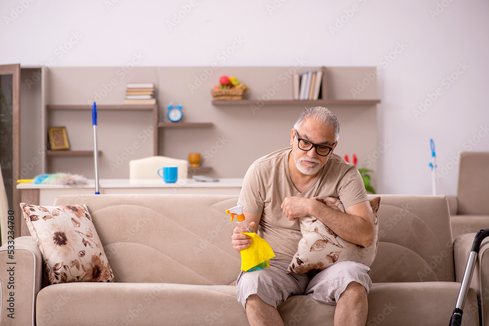 Old man doing housework at home Old man doing housework at home