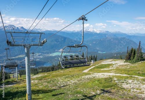A chair lift descends down a steep ski hill in the summer at Whistler British Columbia.
