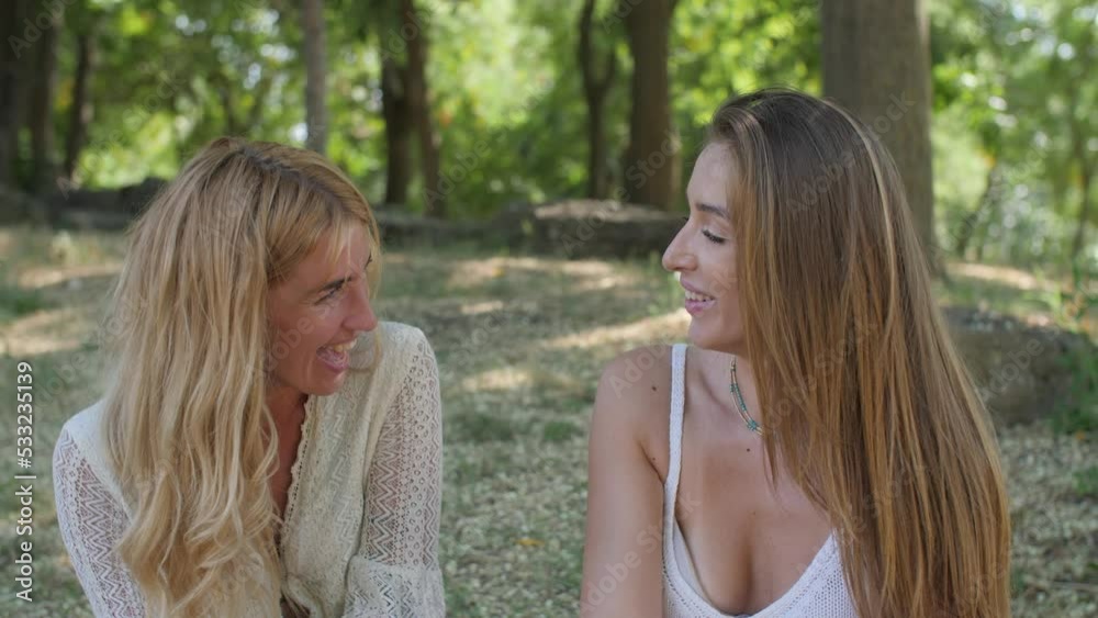 portrait of two girlfriends talking and then turn and look at the camera smiling portrait of two girlfriends talking and then turn and look at the camera smiling