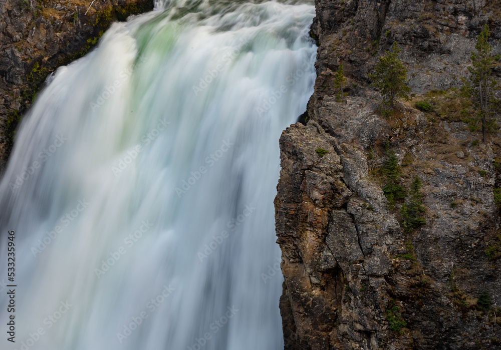 Solid Rock And Flowing Water Compete For Space At The Upper Falls Of The Yellowstone River