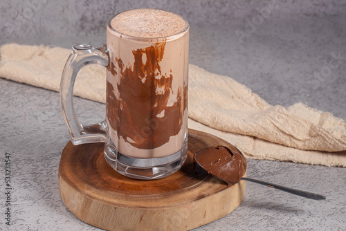 Delicious chocolate milkshake on gray background